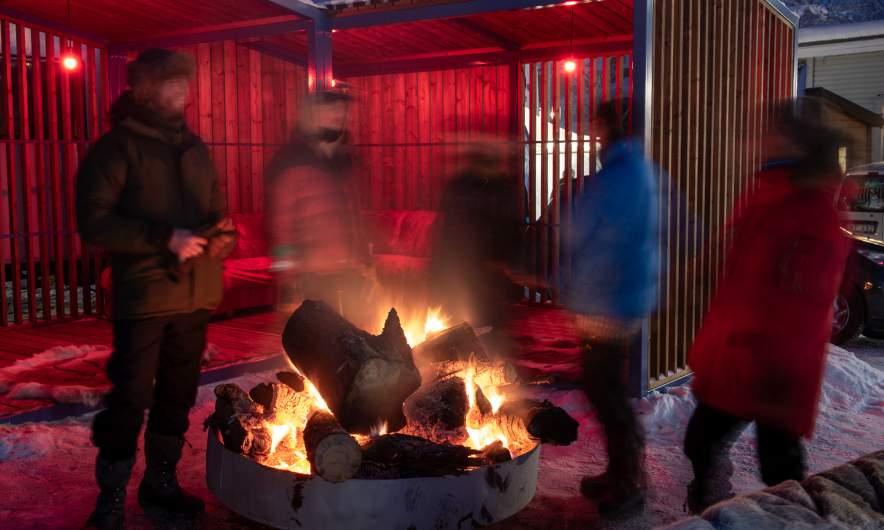 People having fun around the open fire