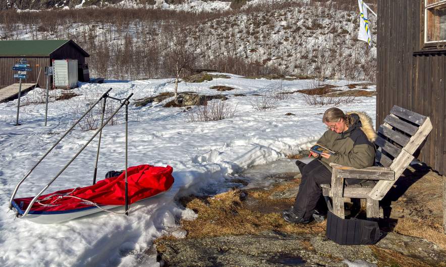 Annika is reading and the pulka is drying in the sun